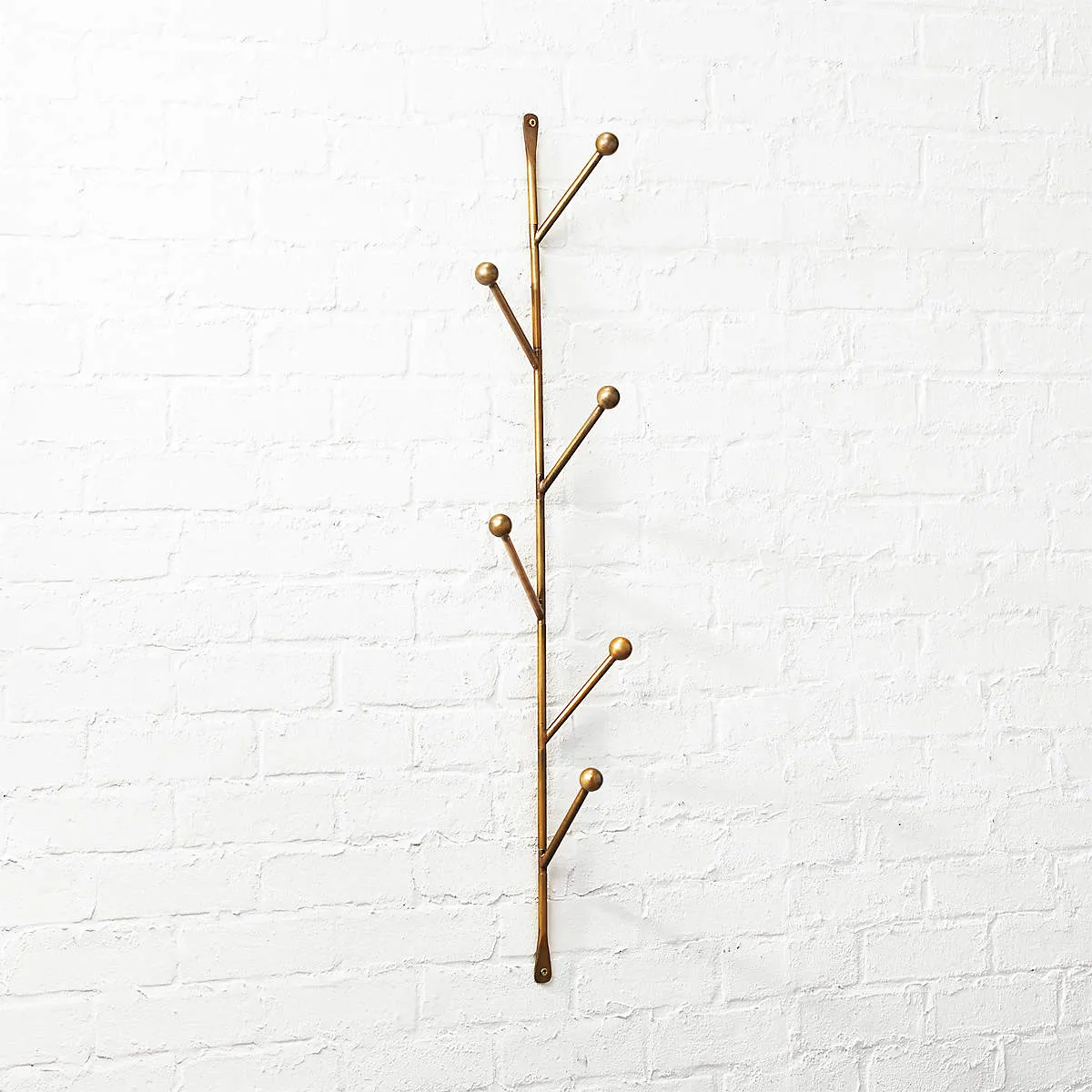 NEW Barker Sculptural Vertical Wall Mounted Coat Rack, crafted from Iron with a warm gold finish, also ideal in the bedroom for necklaces, scarves, and your favorite cozy robe.